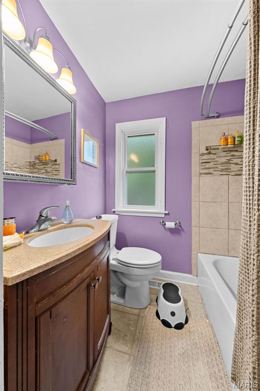 100 Calverton Rd, Saint Louis, MO 63135 - bathroom featuring tile patterned floors, vanity, and shower / bath combo