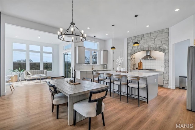 213 Bluegrass Pasture Ct, Wentzville, MO 63385 - dining area featuring recessed lighting, light wood-style flooring, and a chandelier