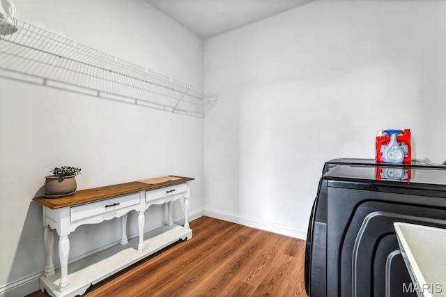 213 Bluegrass Pasture Ct, Wentzville, MO 63385 - laundry area with wood finished floors and baseboards