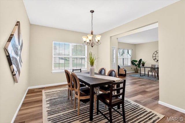 621 Royal Crest Way, Ofallon, IL 62269 - dining space featuring a chandelier, plenty of natural light, and wood finished floors