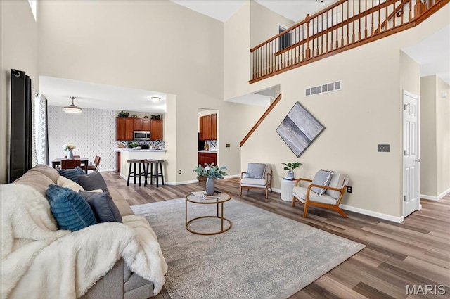 621 Royal Crest Way, Ofallon, IL 62269 - living area with light wood-style floors, a high ceiling, and wallpapered walls