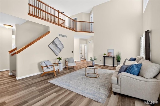 621 Royal Crest Way, Ofallon, IL 62269 - living area featuring a towering ceiling, stairway, and wood finished floors