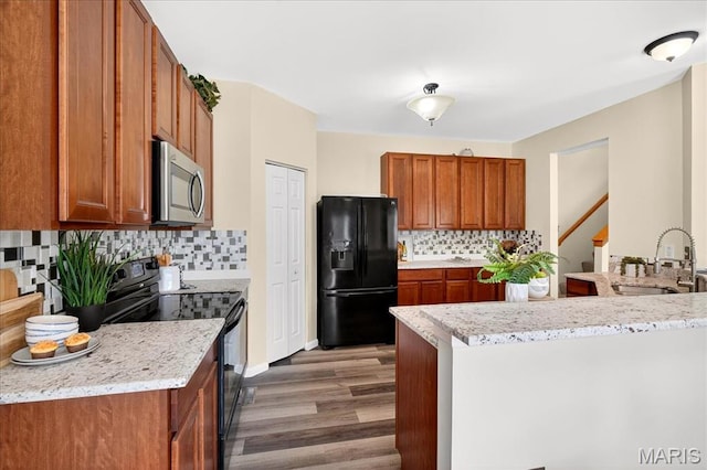 621 Royal Crest Way, Ofallon, IL 62269 - kitchen with black appliances, brown cabinets, and wood finished floors