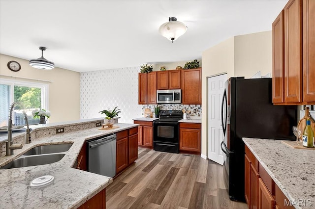 621 Royal Crest Way, Ofallon, IL 62269 - kitchen with black appliances, brown cabinetry, light stone countertops, and wood finished floors
