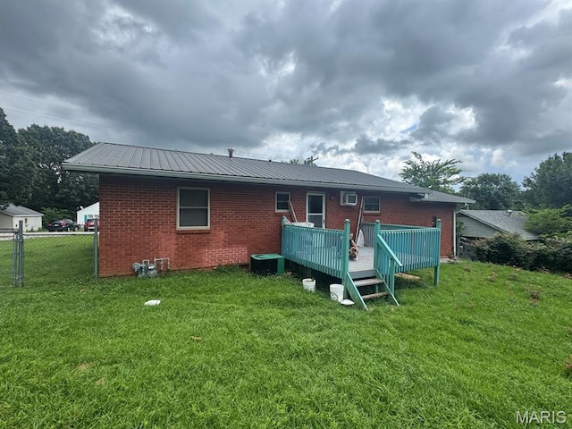 737 Price St, Poplar Bluff, MO 63901 - back of house with brick siding, a deck, and a metal roof