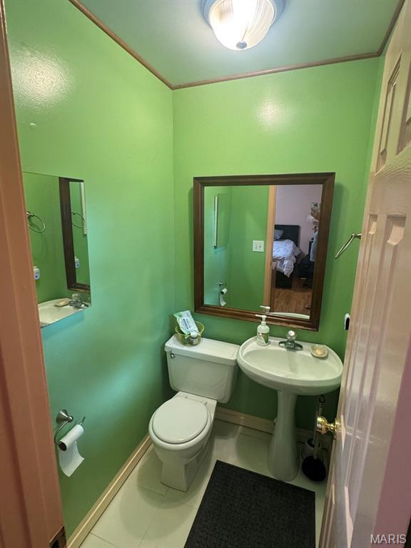 737 Price St, Poplar Bluff, MO 63901 - half bath featuring toilet and tile patterned floors