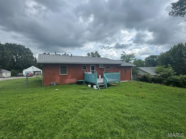 737 Price St, Poplar Bluff, MO 63901 - rear view of property with brick siding, a wooden deck, and a metal roof