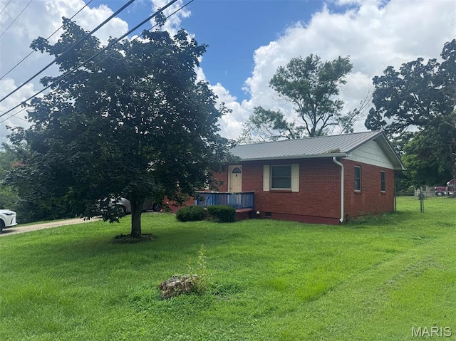 737 Price St, Poplar Bluff, MO 63901 - view of side of property with brick siding, a lawn, and a metal roof
