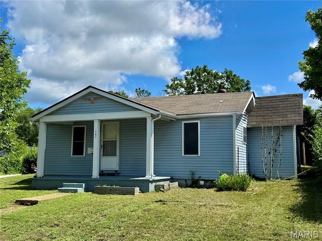 207 Cordia Ave, Potosi, MO 63664 - view of front of house with roof with shingles, covered porch, and a front lawn