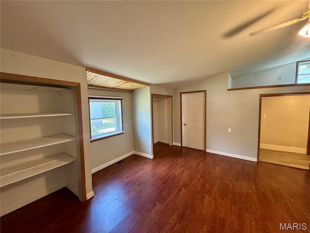 207 Cordia Ave, Potosi, MO 63664 - unfurnished bedroom with multiple windows, wood finished floors, vaulted ceiling, ceiling fan, and a textured ceiling