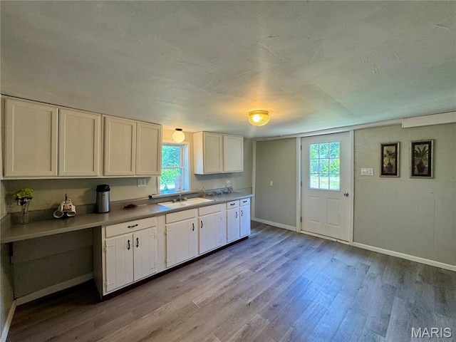 207 Cordia Ave, Potosi, MO 63664 - kitchen with wood finished floors, plenty of natural light, and white cabinetry
