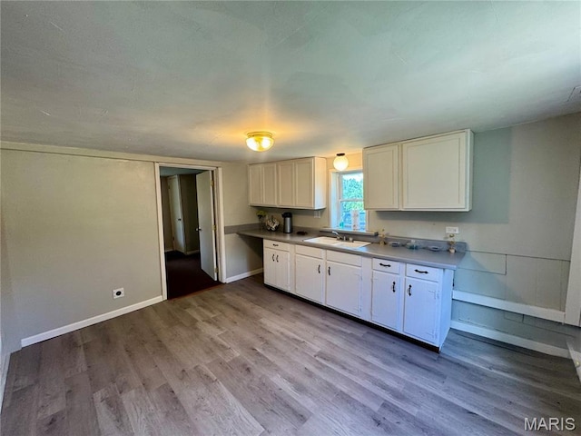 207 Cordia Ave, Potosi, MO 63664 - kitchen with wood finished floors, white cabinets, and light countertops