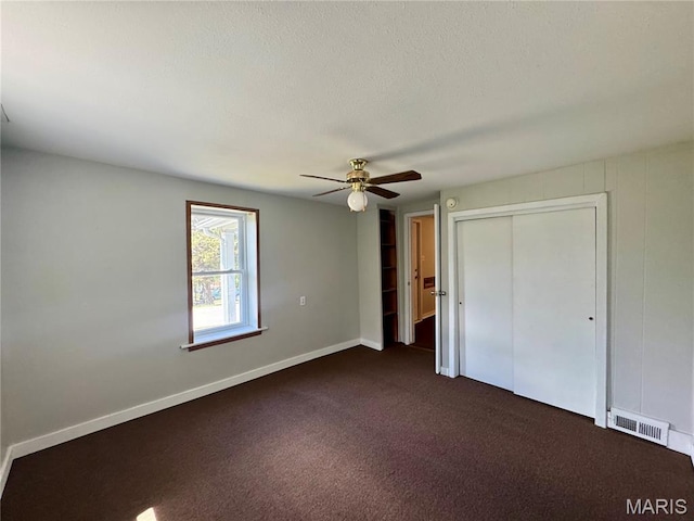 207 Cordia Ave, Potosi, MO 63664 - unfurnished bedroom featuring dark carpet, a closet, and ceiling fan