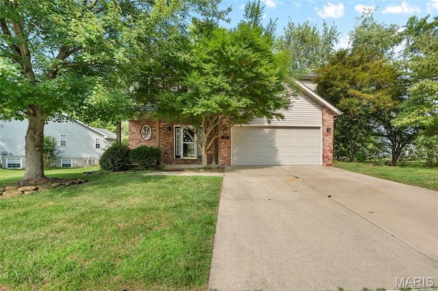 1817 Partridge Pl, Edwardsville, IL 62025 - view of property hidden behind natural elements featuring brick siding, driveway, a front yard, and a garage