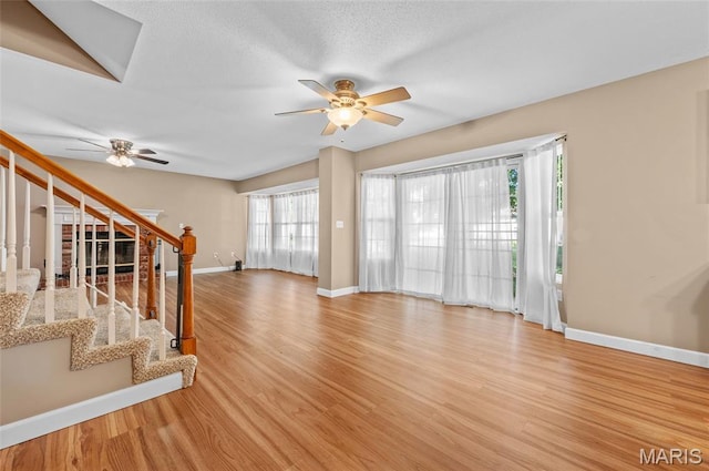 1817 Partridge Pl, Edwardsville, IL 62025 - unfurnished living room featuring a ceiling fan, stairway, and light wood finished floors