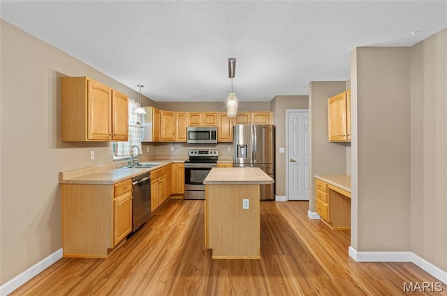 1817 Partridge Pl, Edwardsville, IL 62025 - kitchen with appliances with stainless steel finishes, light wood-type flooring, and a kitchen island