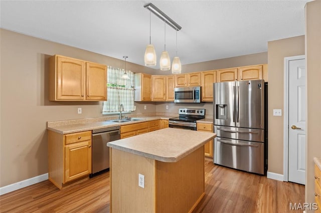1817 Partridge Pl, Edwardsville, IL 62025 - kitchen featuring stainless steel appliances, light brown cabinetry, light countertops, light wood-style floors, and a center island