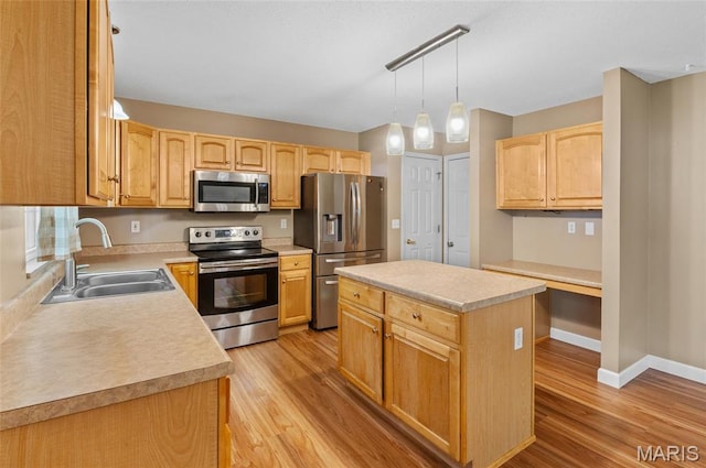 1817 Partridge Pl, Edwardsville, IL 62025 - kitchen featuring stainless steel appliances, light wood finished floors, light countertops, and a kitchen island