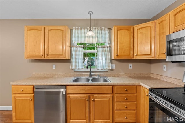 1817 Partridge Pl, Edwardsville, IL 62025 - kitchen featuring appliances with stainless steel finishes, light countertops, decorative light fixtures, light brown cabinetry, and wood finished floors