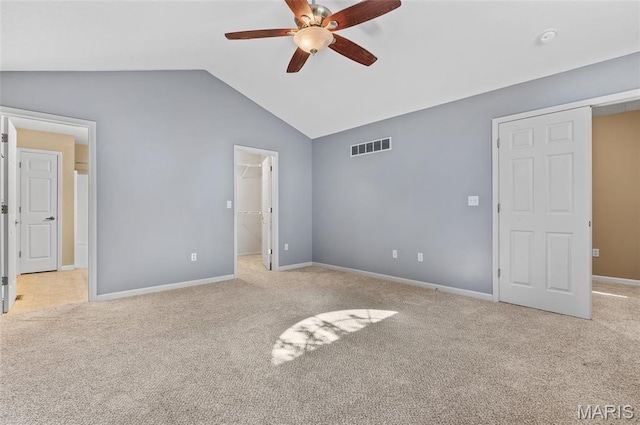 1817 Partridge Pl, Edwardsville, IL 62025 - unfurnished bedroom with light carpet, lofted ceiling, a walk in closet, and ceiling fan