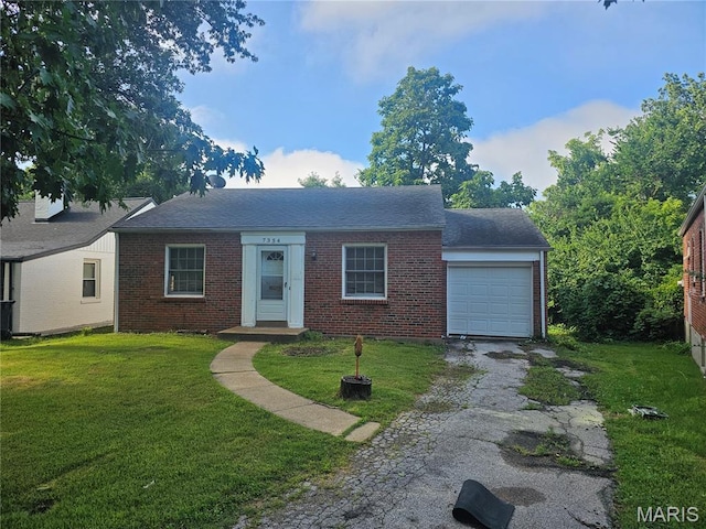 7354 Trenton Ave, Saint Louis, MO 63130 - view of front of house featuring a garage, asphalt driveway, brick siding, and a front yard