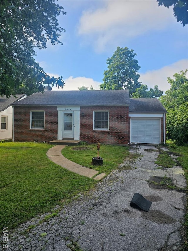 7354 Trenton Ave, Saint Louis, MO 63130 - single story home with a garage, driveway, brick siding, and a front yard