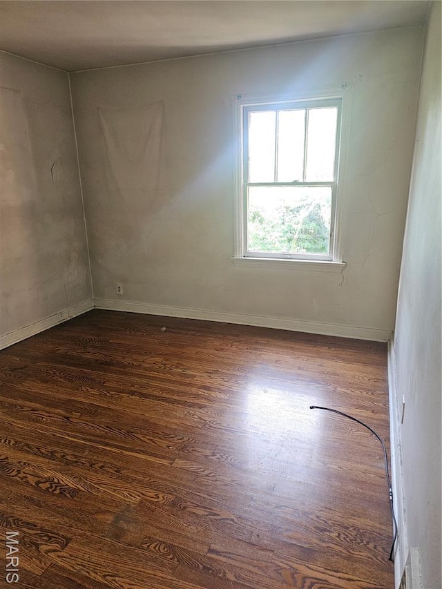 7354 Trenton Ave, Saint Louis, MO 63130 - empty room featuring dark wood-type flooring and baseboards