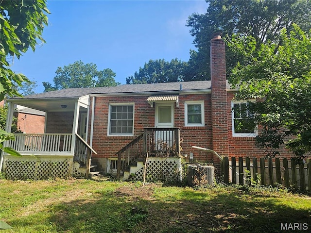 7354 Trenton Ave, Saint Louis, MO 63130 - rear view of house featuring brick siding, a chimney, and a lawn