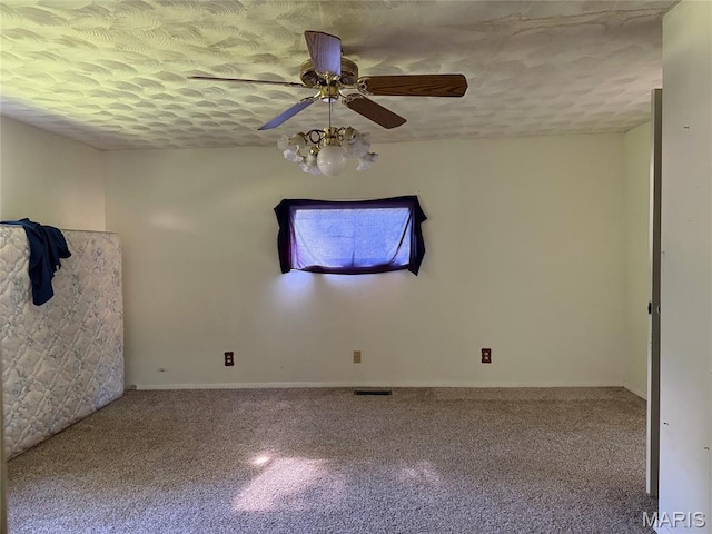 913 W Edwards St, Vandalia, IL 62471 - unfurnished room with carpet, a ceiling fan, and a textured ceiling