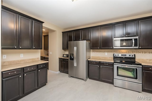 510 Newkirk Cir, Saint Charles, MO 63303 - kitchen with appliances with stainless steel finishes, light countertops, and decorative backsplash