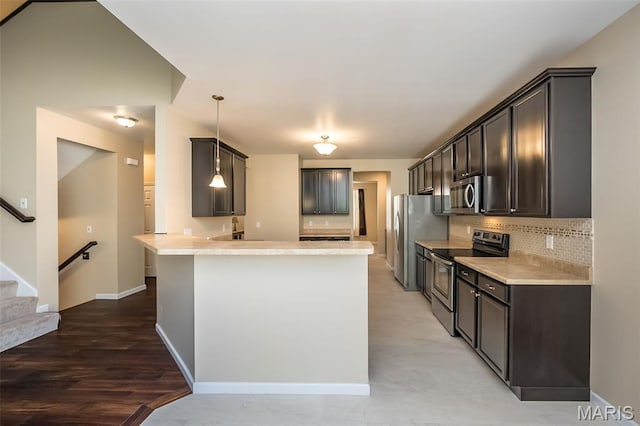 510 Newkirk Cir, Saint Charles, MO 63303 - kitchen featuring appliances with stainless steel finishes, a peninsula, decorative backsplash, and light countertops