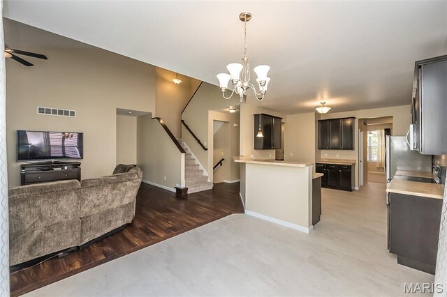 510 Newkirk Cir, Saint Charles, MO 63303 - kitchen featuring open floor plan, light countertops, freestanding refrigerator, a chandelier, and light wood-style floors