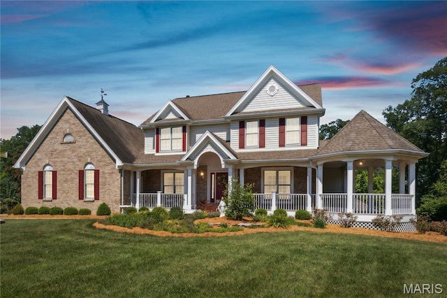 1605 High Sierra Dr, Foristell, MO 63348 - view of front of house with covered porch, a front lawn, brick siding, and roof with shingles