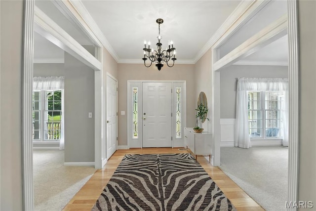 1605 High Sierra Dr, Foristell, MO 63348 - foyer entrance with a chandelier, light wood-style floors, and ornamental molding
