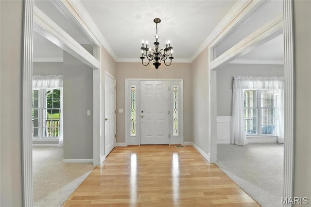 1605 High Sierra Dr, Foristell, MO 63348 - entrance foyer with a chandelier, light wood-type flooring, crown molding, and light carpet