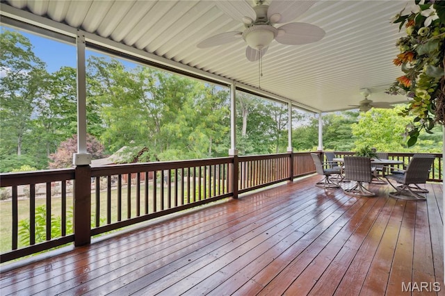 1605 High Sierra Dr, Foristell, MO 63348 - wooden deck featuring ceiling fan, outdoor dining space, and view of wooded area
