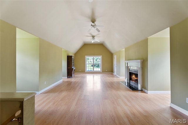 1605 High Sierra Dr, Foristell, MO 63348 - unfurnished living room featuring a ceiling fan, light wood-style flooring, a high end fireplace, and lofted ceiling