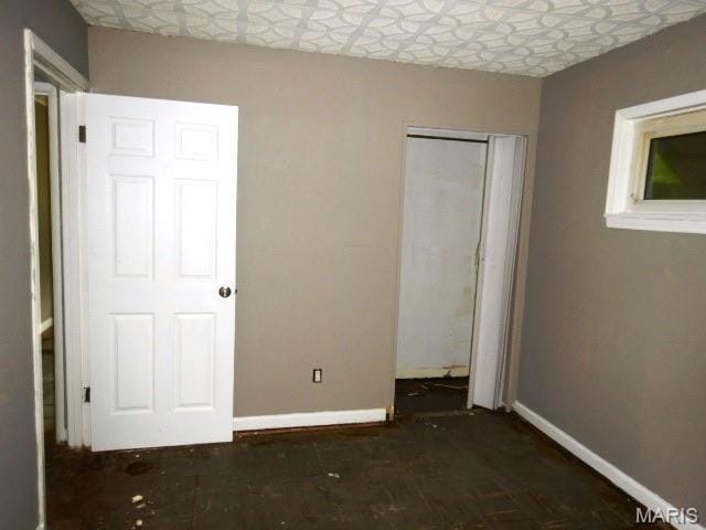 11947 Bridgevale Ave, Saint Louis, MO 63138 - unfurnished bedroom featuring baseboards and a closet