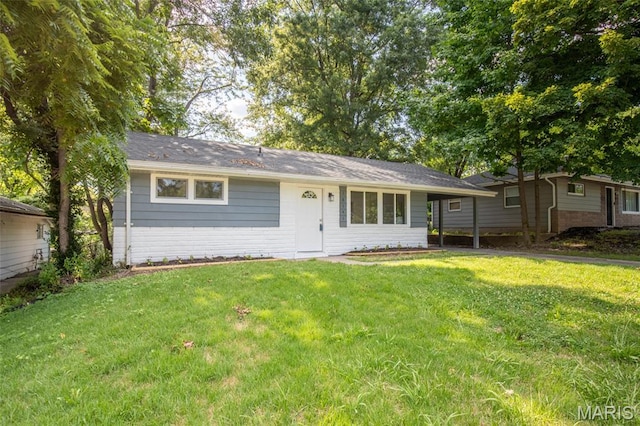 10141 Ventura Dr, Ferguson Township, MO 63136 - ranch-style house with a front lawn, brick siding, and a carport