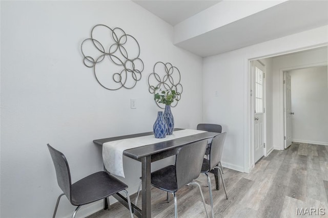 10141 Ventura Dr, Ferguson Township, MO 63136 - dining room with light wood-type flooring and baseboards