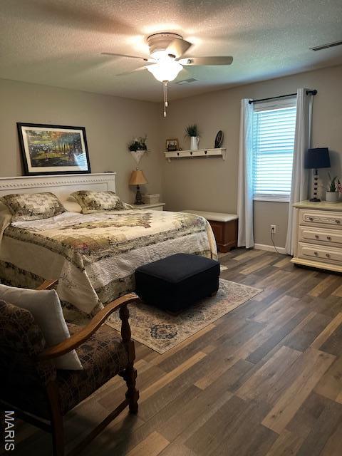 1010 Pine St, Sikeston, MO 63801 - bedroom with a textured ceiling, dark wood finished floors, and ceiling fan