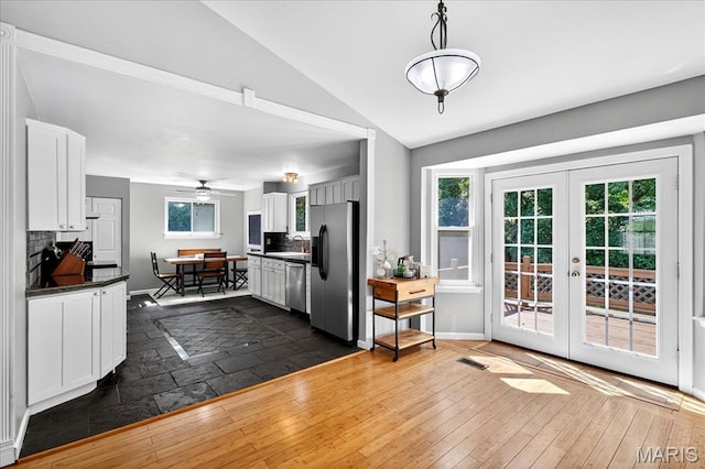 1826 Fairwood Forest Dr, Saint Peters, MO 63376 - kitchen with stainless steel appliances, decorative backsplash, dark countertops, vaulted ceiling, and french doors