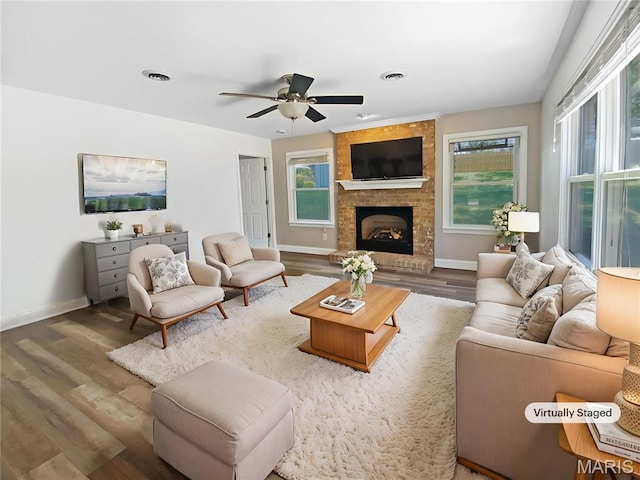 248 Ramsey Ln, Ballwin, MO 63021 - living room with healthy amount of natural light, wood finished floors, a ceiling fan, and a brick fireplace