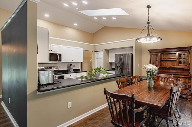 1923 Smizer Mill Rd, Fenton, MO 63026 - dining space featuring dark wood-type flooring, a skylight, lofted ceiling, and recessed lighting