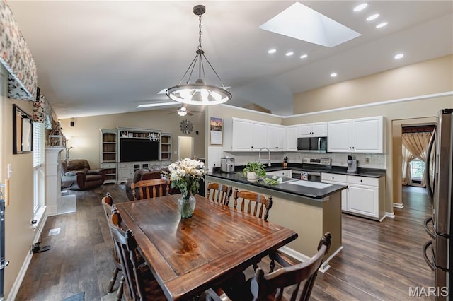 1923 Smizer Mill Rd, Fenton, MO 63026 - dining room featuring vaulted ceiling, dark wood finished floors, a skylight, ceiling fan, and recessed lighting