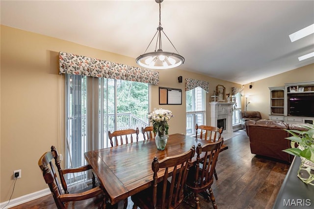 1923 Smizer Mill Rd, Fenton, MO 63026 - dining area with dark wood-style floors, a fireplace, vaulted ceiling, and a skylight