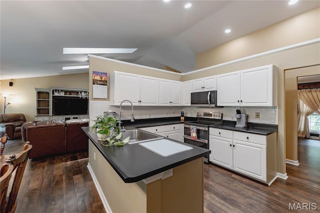 1923 Smizer Mill Rd, Fenton, MO 63026 - kitchen featuring appliances with stainless steel finishes, dark countertops, lofted ceiling, dark wood finished floors, and white cabinetry