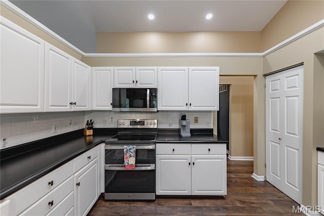 1923 Smizer Mill Rd, Fenton, MO 63026 - kitchen featuring appliances with stainless steel finishes, dark countertops, decorative backsplash, white cabinets, and recessed lighting