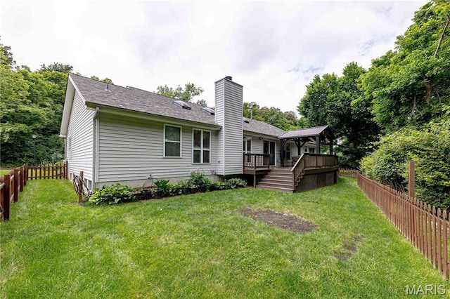 1923 Smizer Mill Rd, Fenton, MO 63026 - rear view of house with a wooden deck, a fenced backyard, a chimney, and a shingled roof