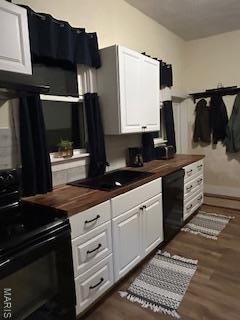 200 N Madison St, Kinmundy, IL 62854 - kitchen with butcher block countertops, black appliances, white cabinetry, and dark wood-type flooring